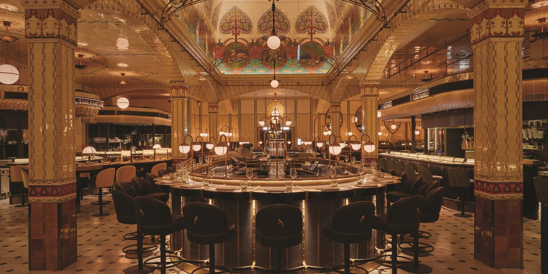 Ornate Harrods dining room with painted ceiling, tiled arches and a circular bar