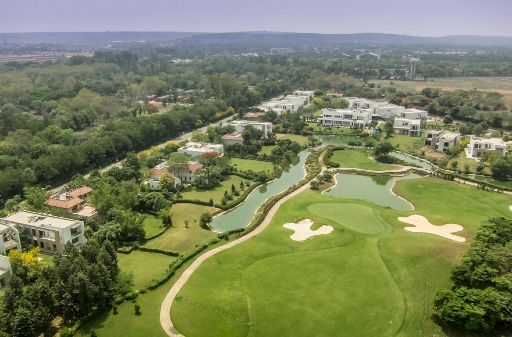 Golf course with greens, water and surrounding villas